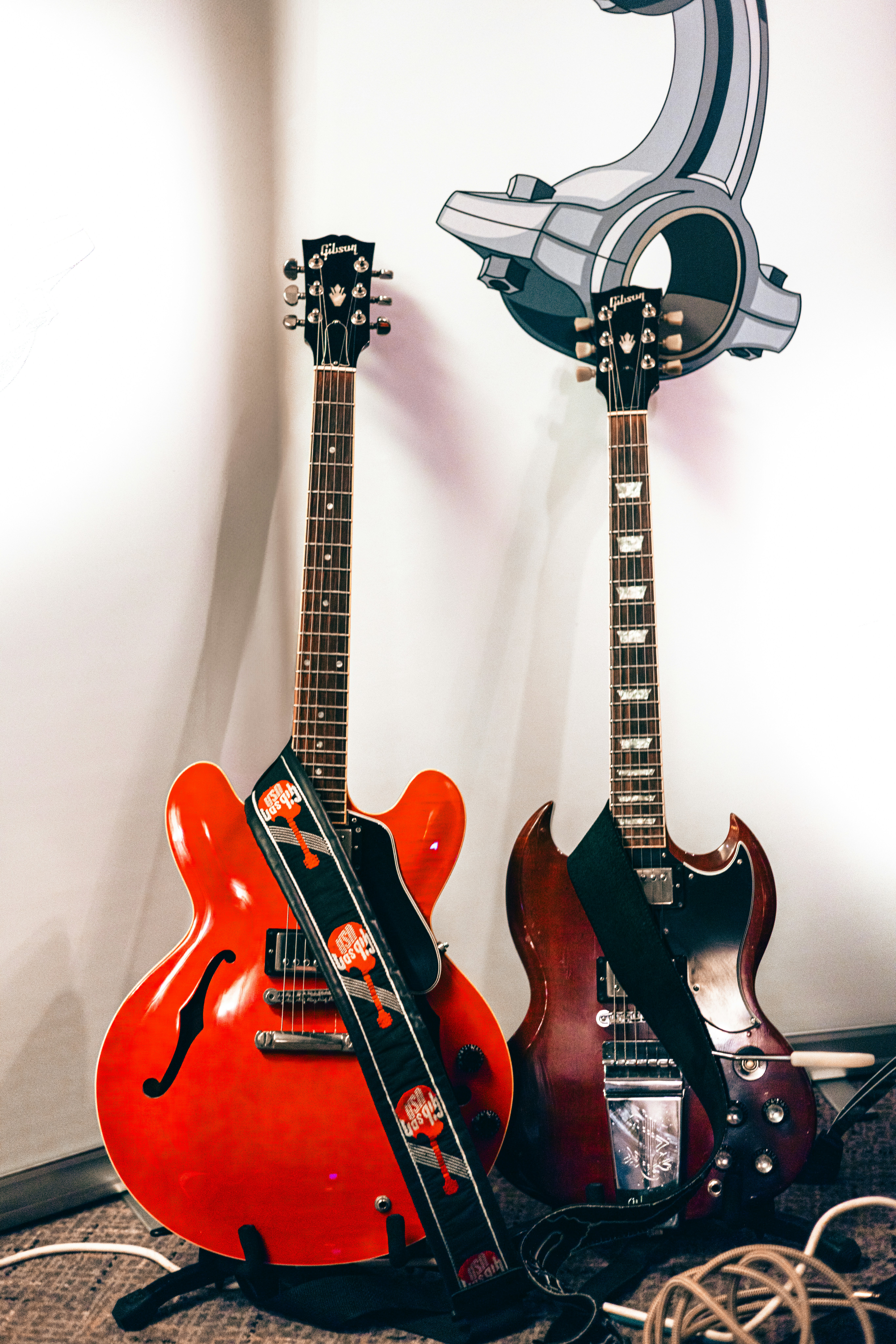 A couple of guitars sitting next to each other