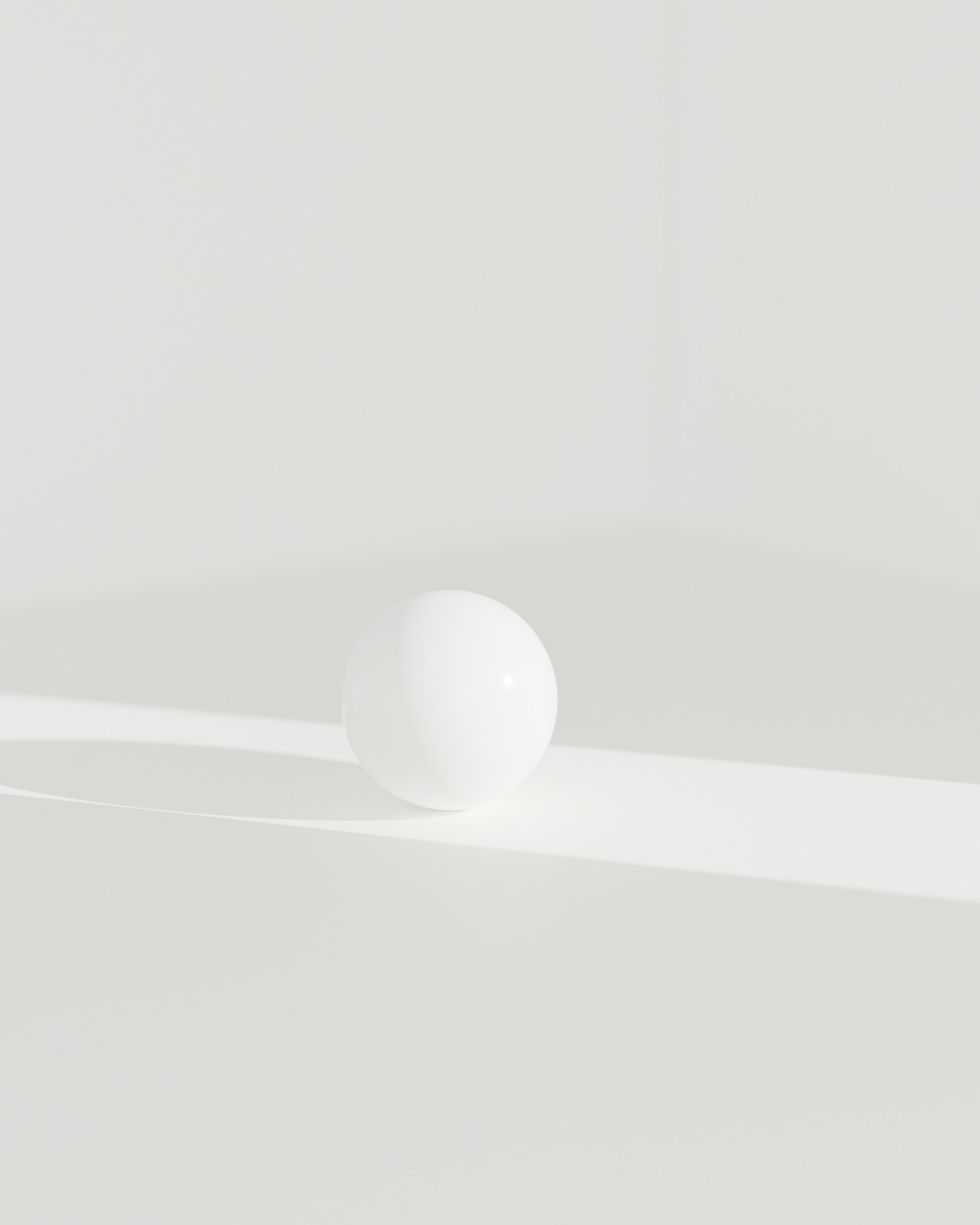 A white ball sitting on top of a white table