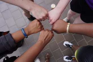A group of people putting their hands together