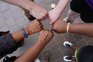 A group of people putting their hands together