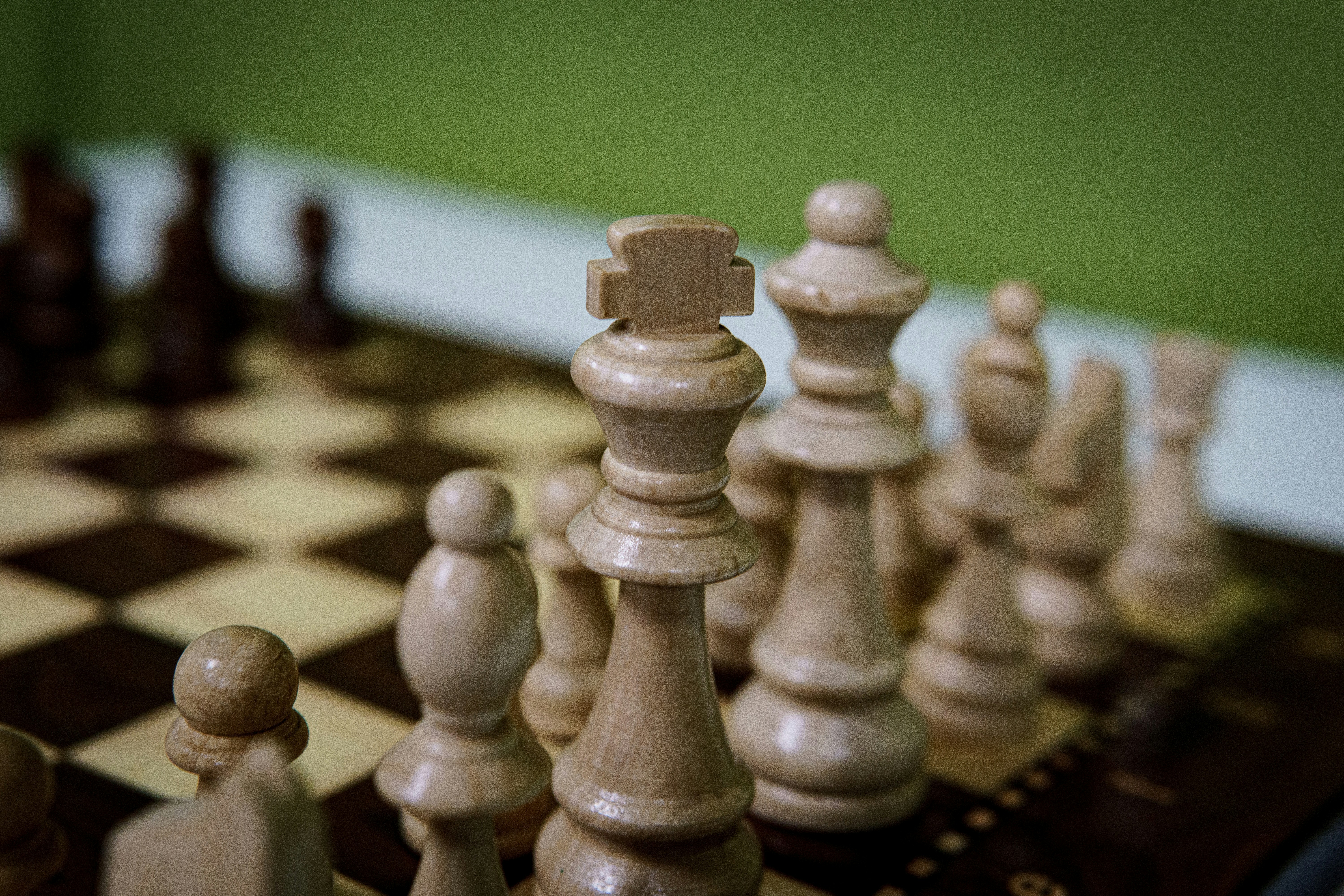 A group of chess pieces sitting on top of a chess board