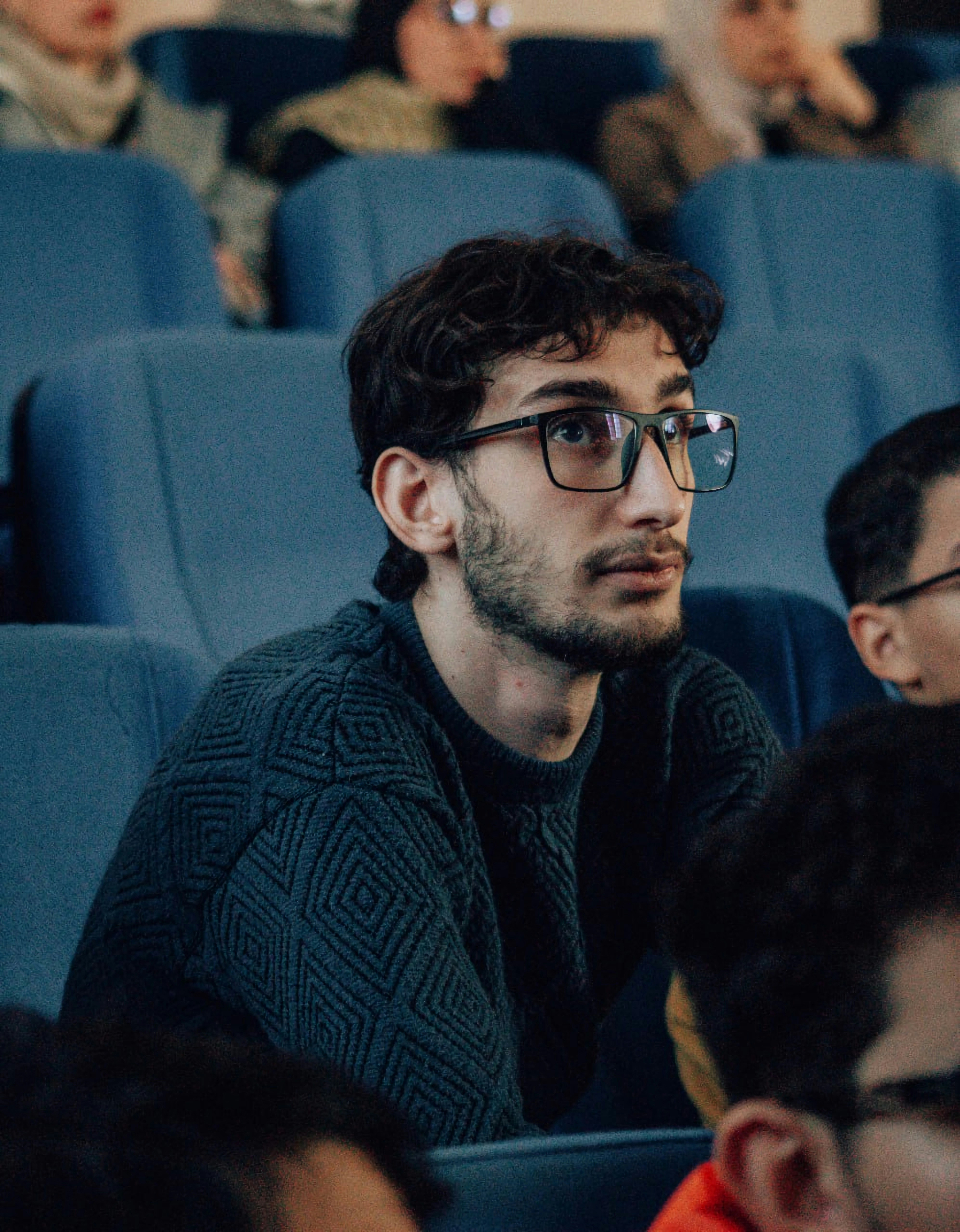 A group of people sitting next to each other