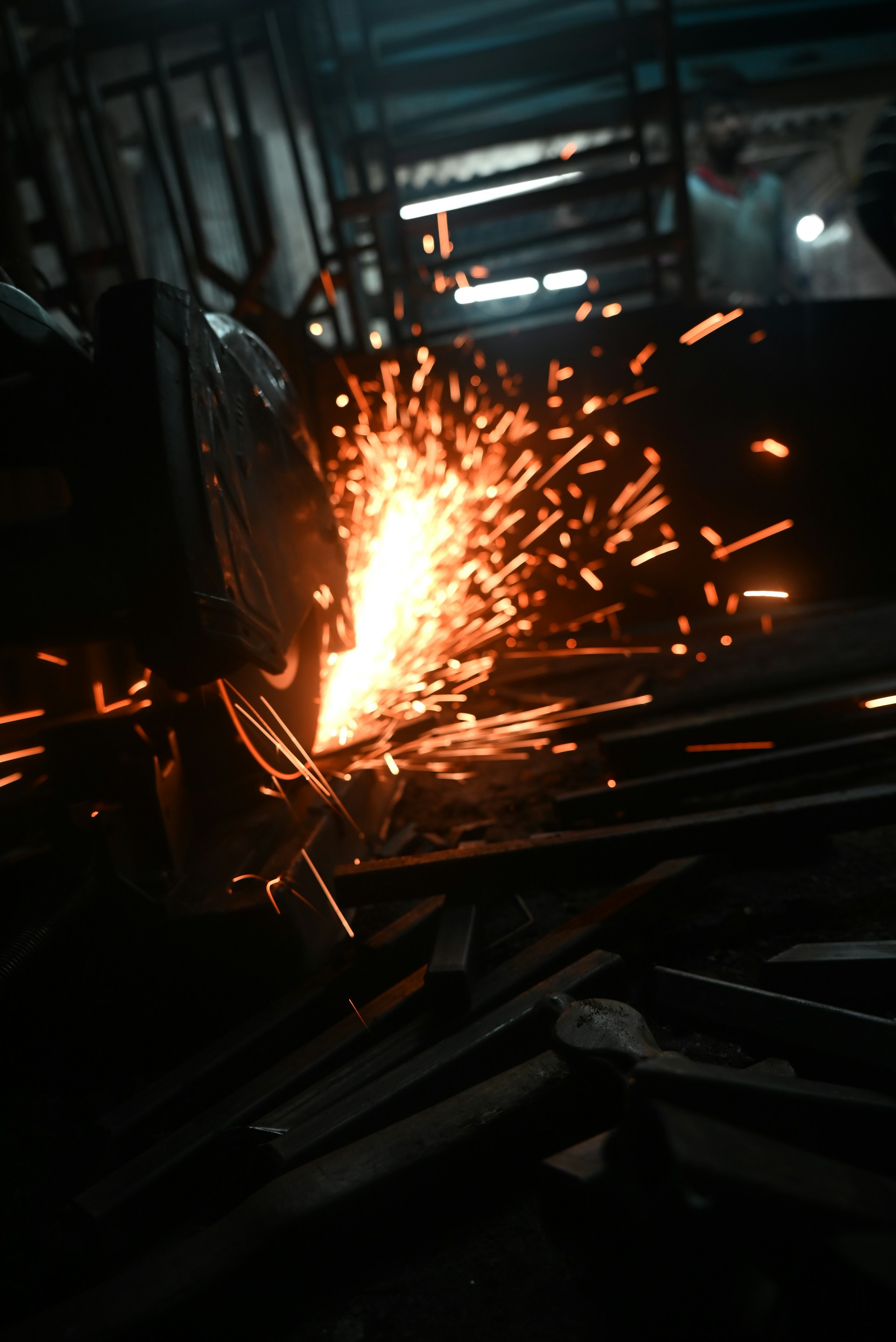 Welder working on a piece of metal in a factory