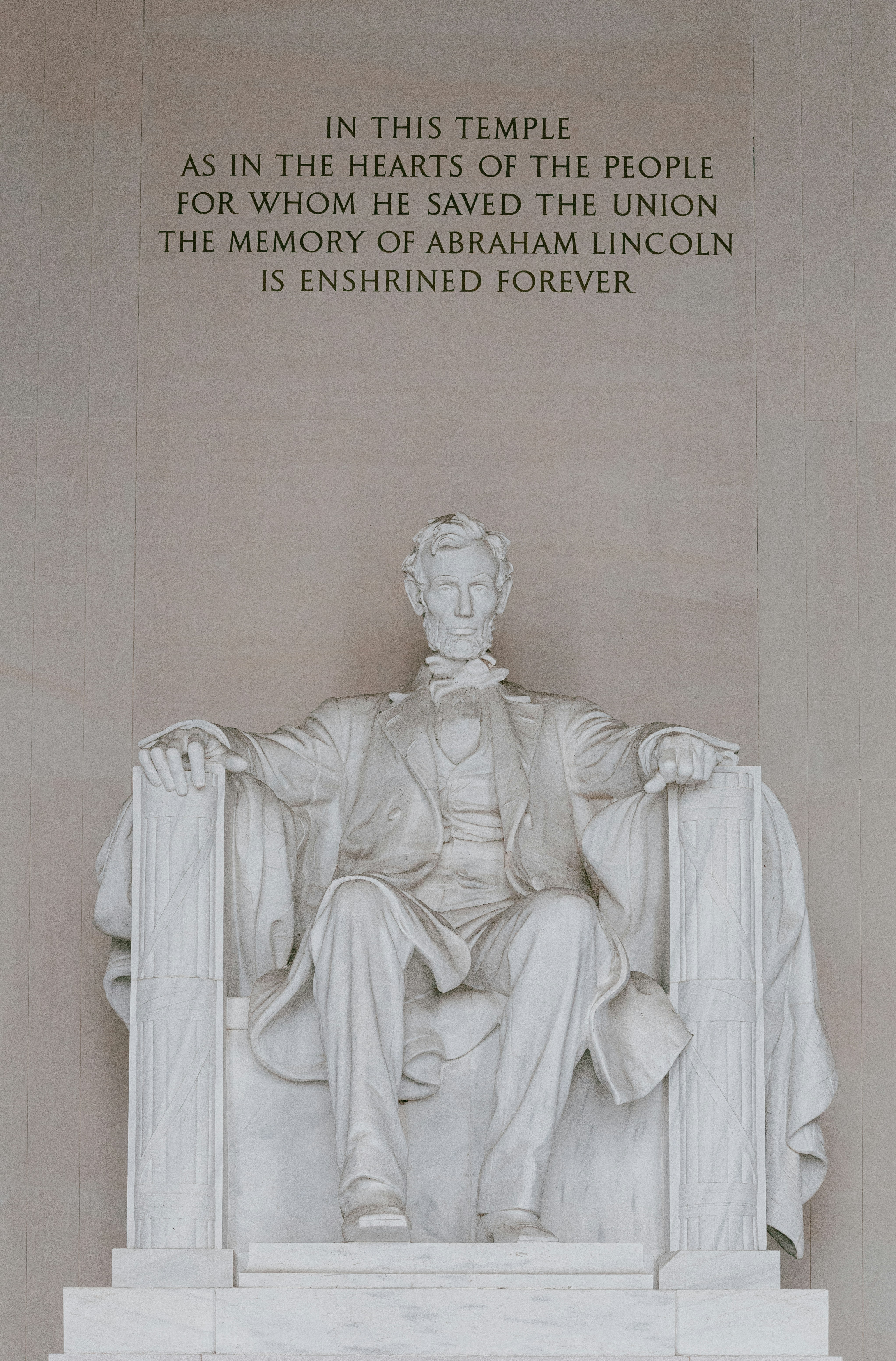 A statue of abraham lincoln in front of the lincoln memorial