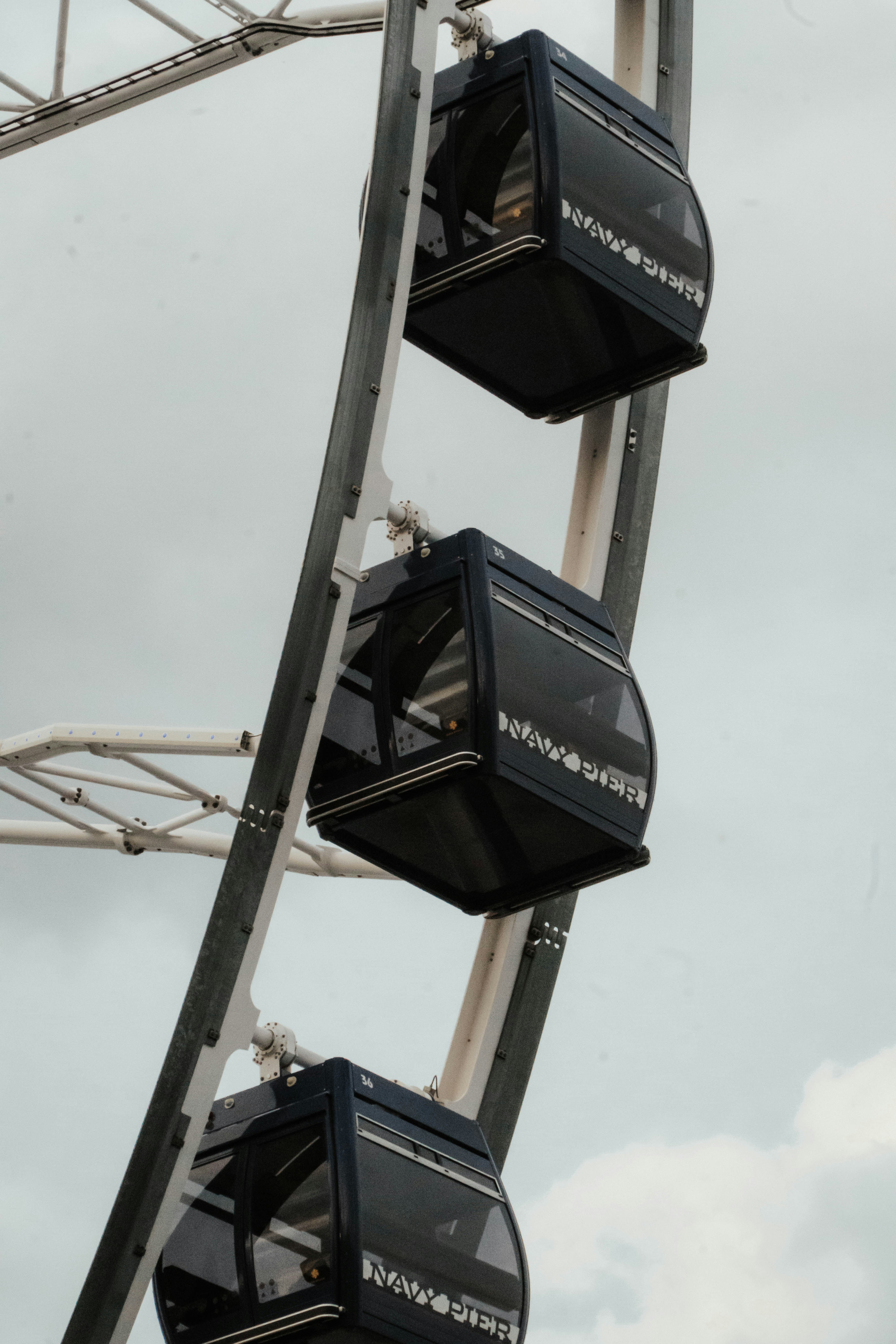 A ferris wheel with four seats on top of it