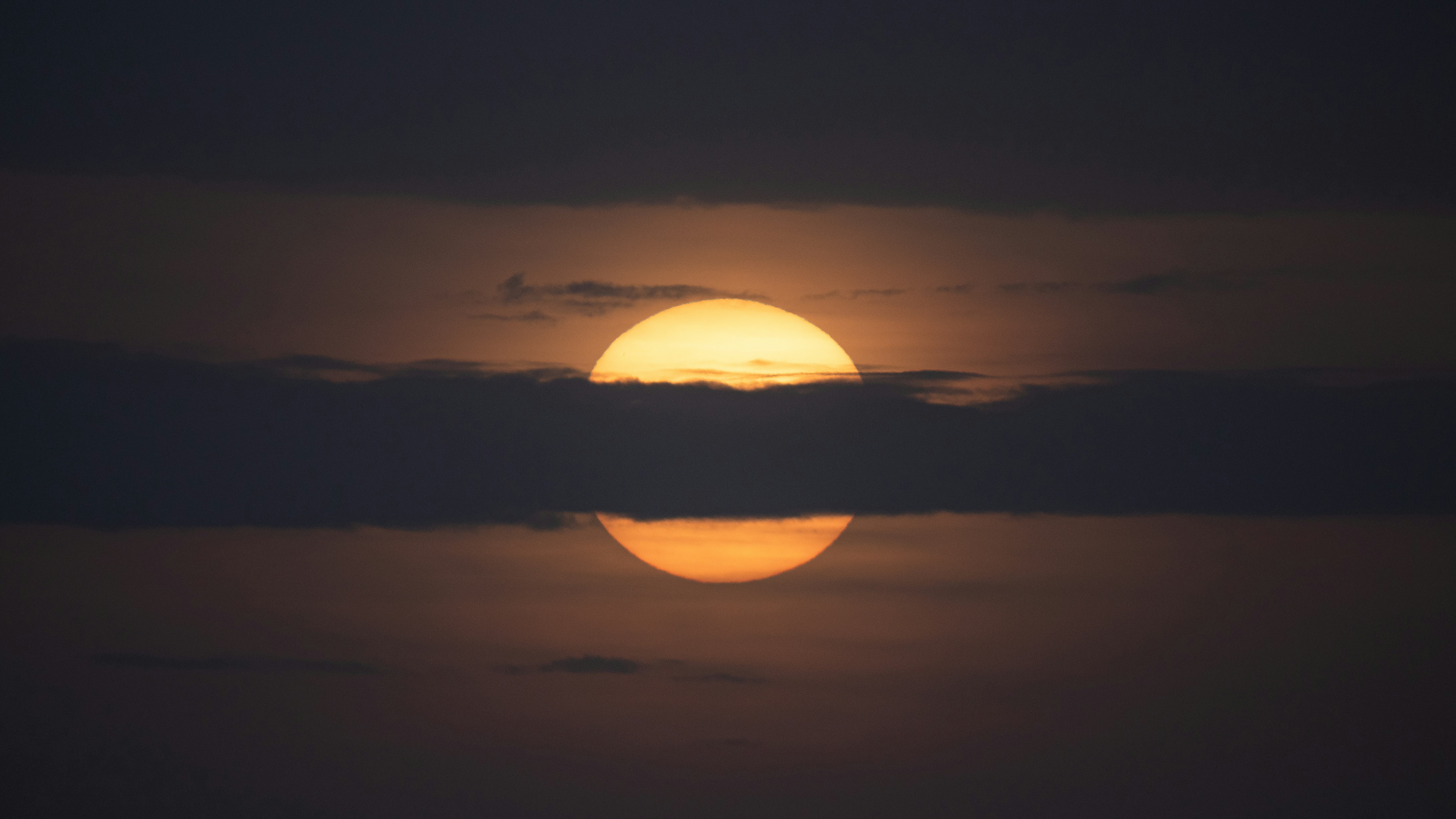 The sun is setting over a body of water