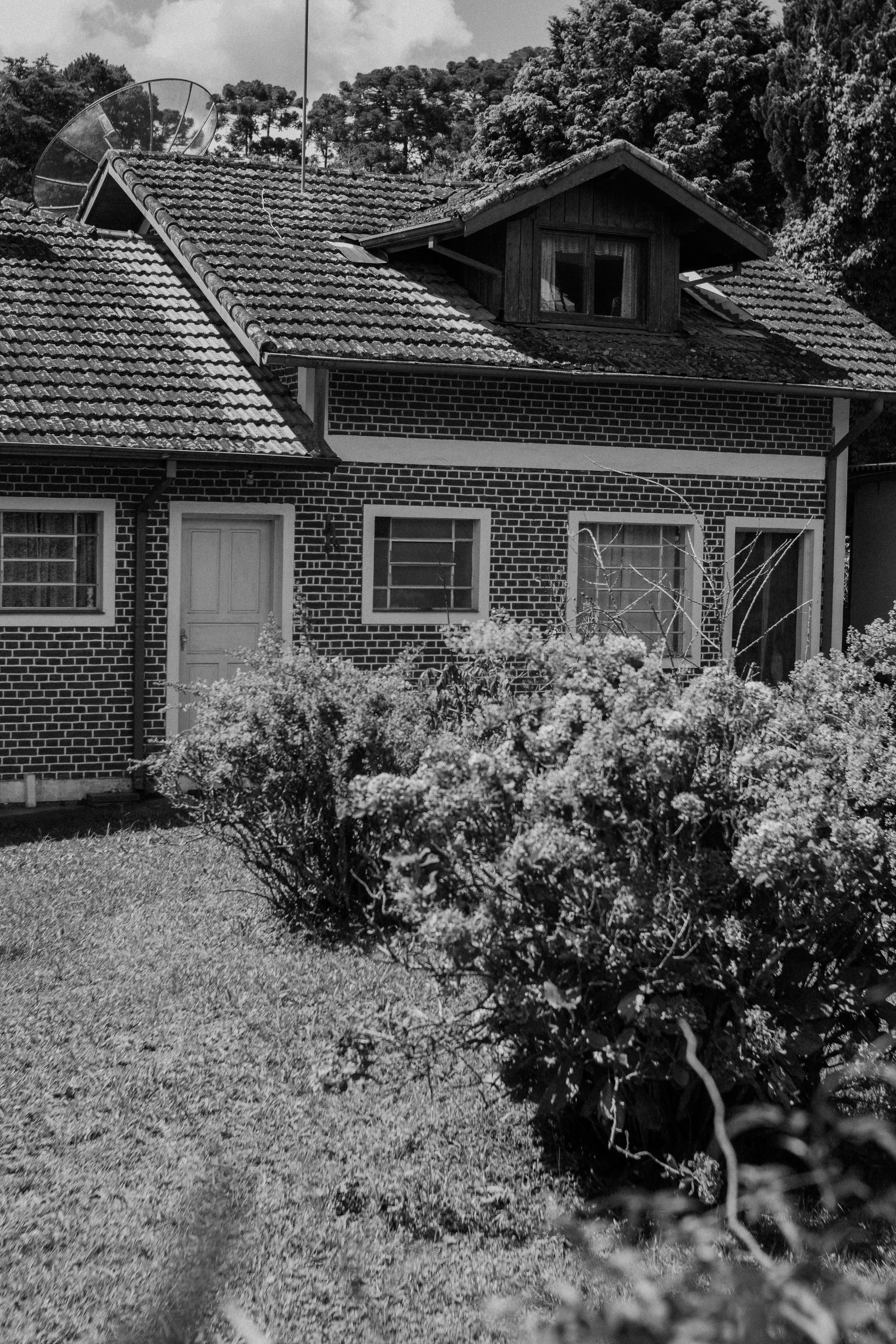 A black and white photo of a brick house
