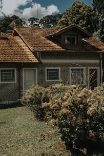 A small brick house with a brown roof