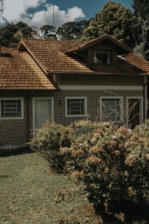A small brick house with a brown roof