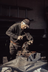 A man working on a machine in a garage