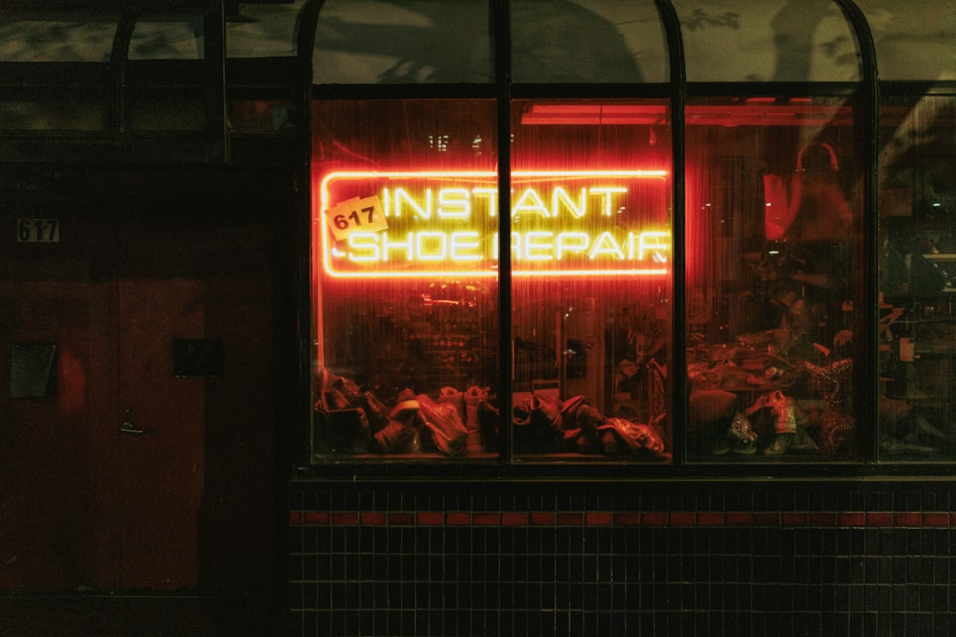 A neon sign in the window of a shoe shop, Instant Shoe Repair