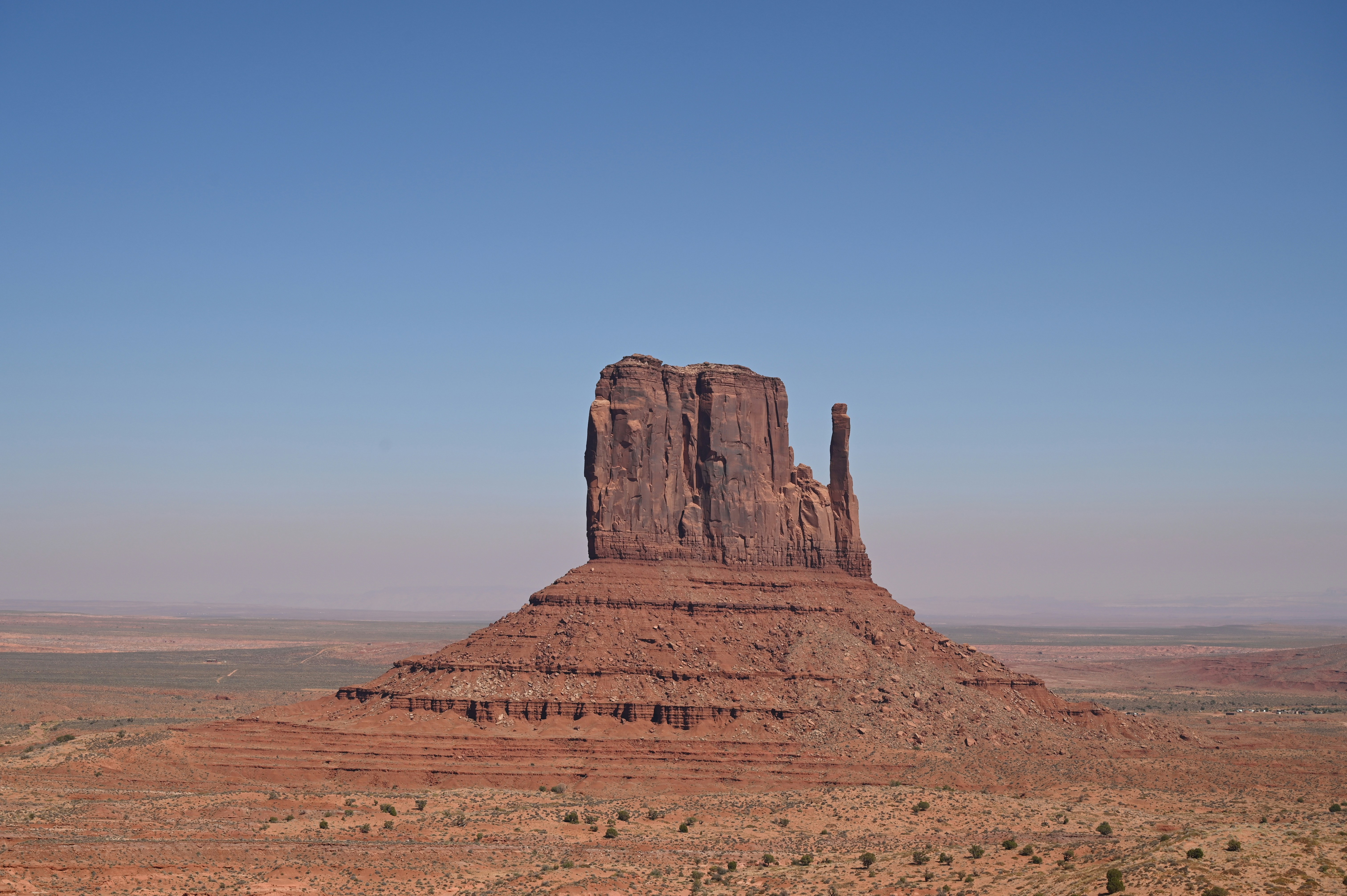 A large rock formation in the middle of a desert