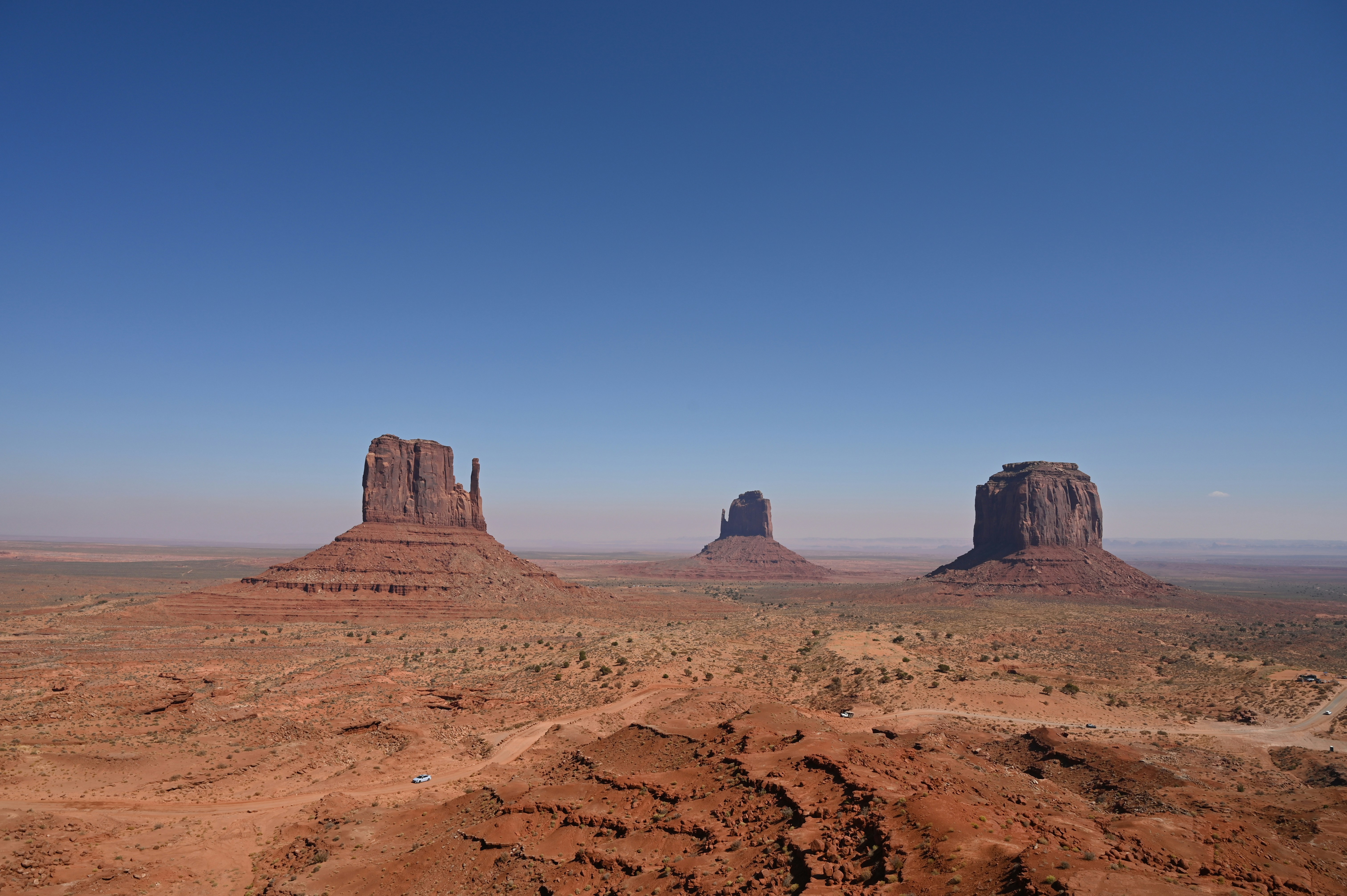 A view of a desert with mountains in the background