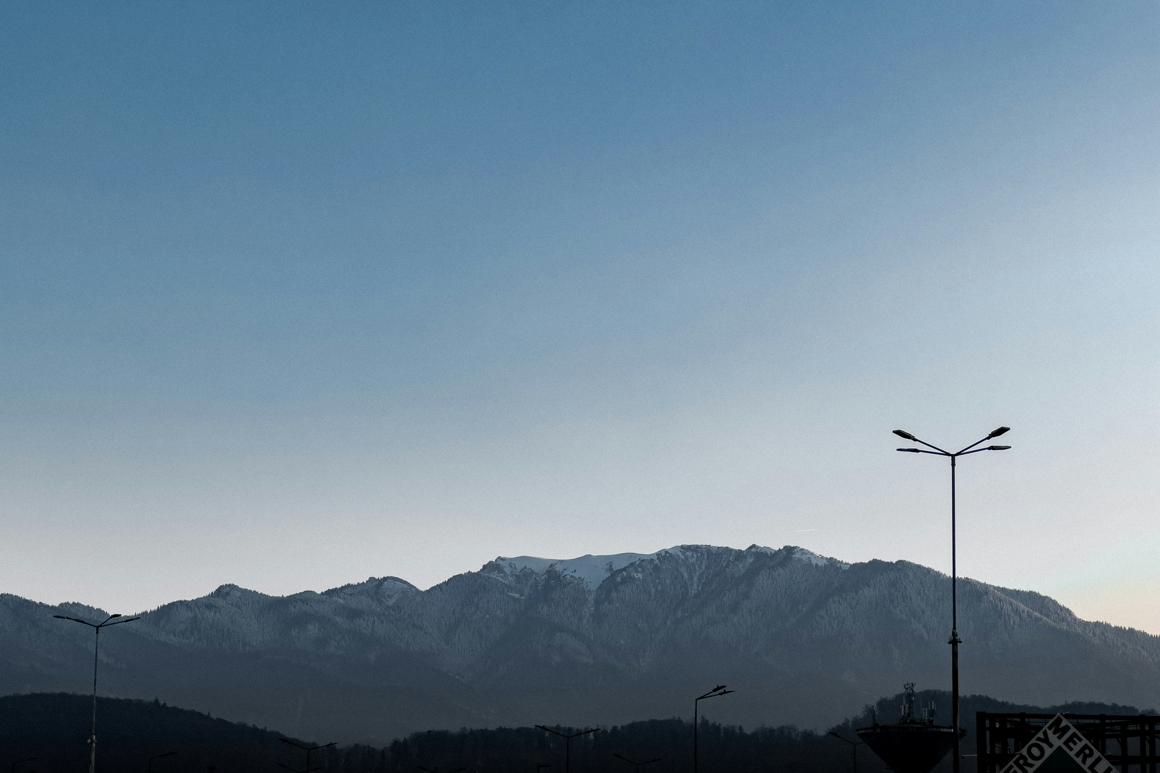 A view of a mountain range from a parking lot