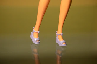 A close up of a doll's legs and shoes