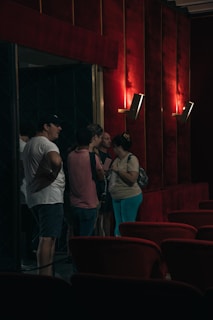 A group of people standing around in a room
