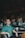 A man sitting at a bar in a green shirt