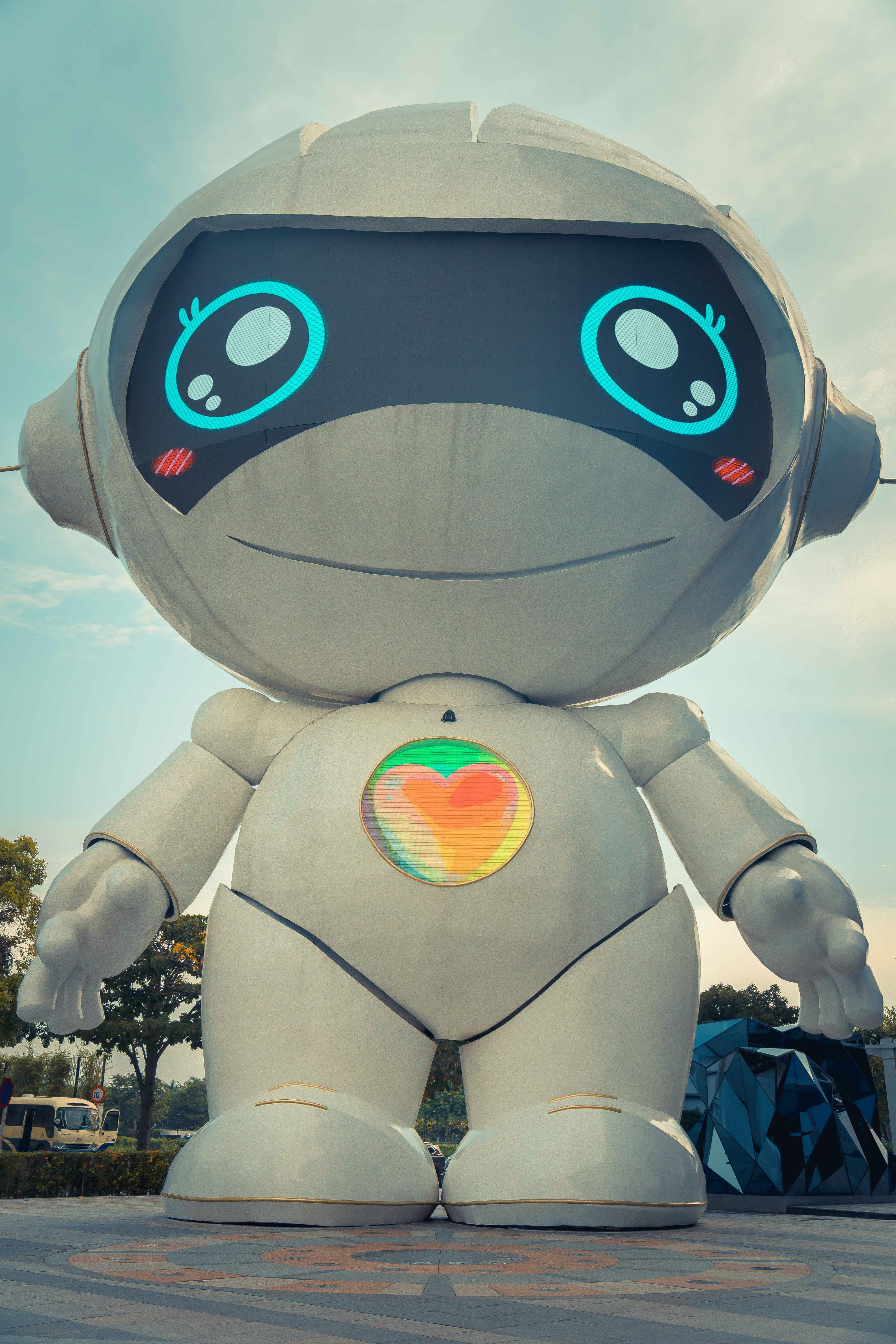 Alt text: Large white robot sitting on top of a parking lot, representing Branimo's innovative technology solutions.