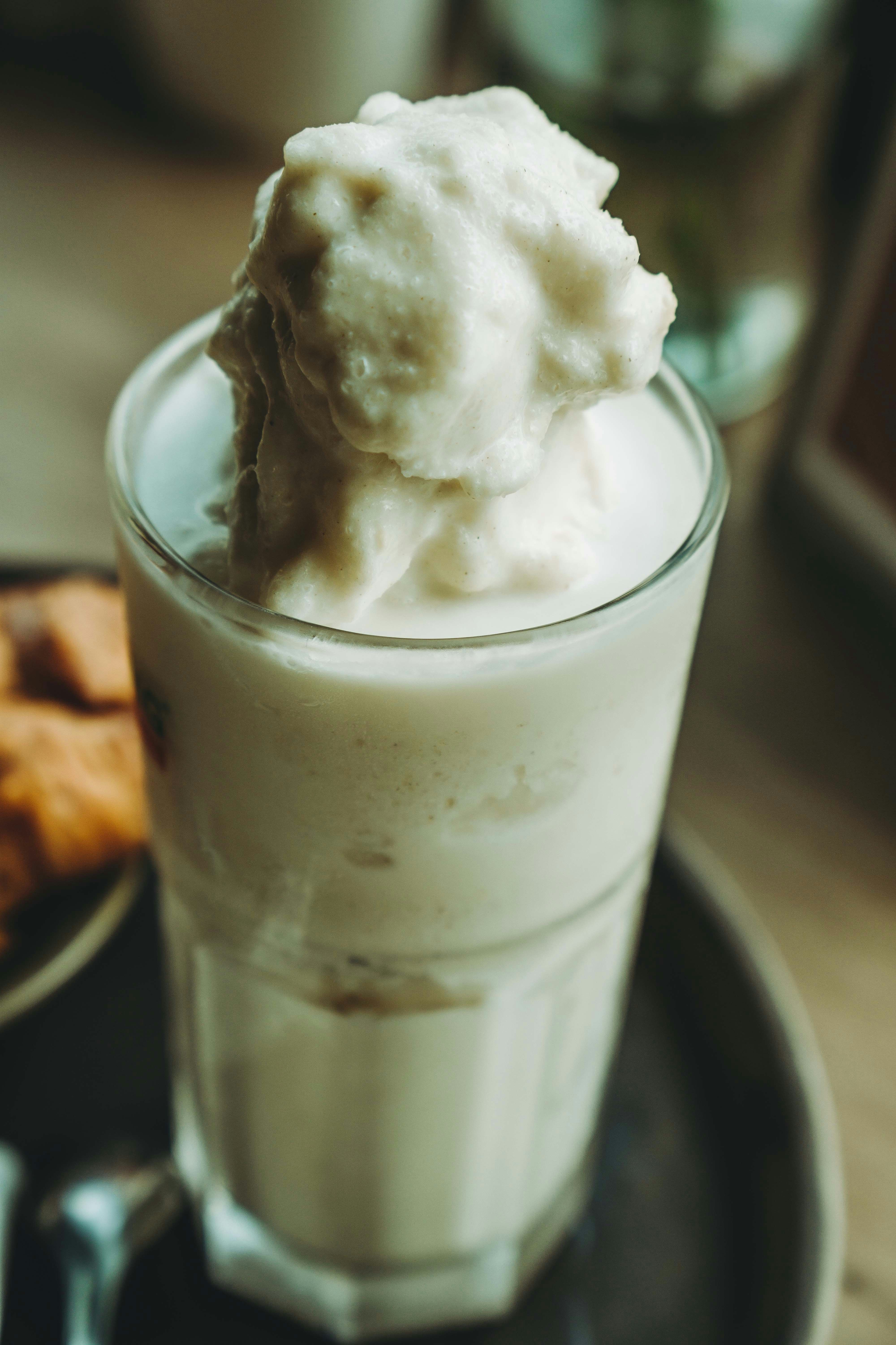 A glass of ice cream sitting on top of a plate