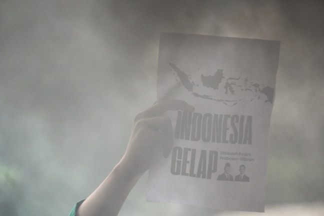 A person holding up a sign in the air