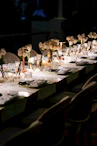 A long table is set with flowers and candles
