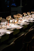 A long table is set with flowers and candles