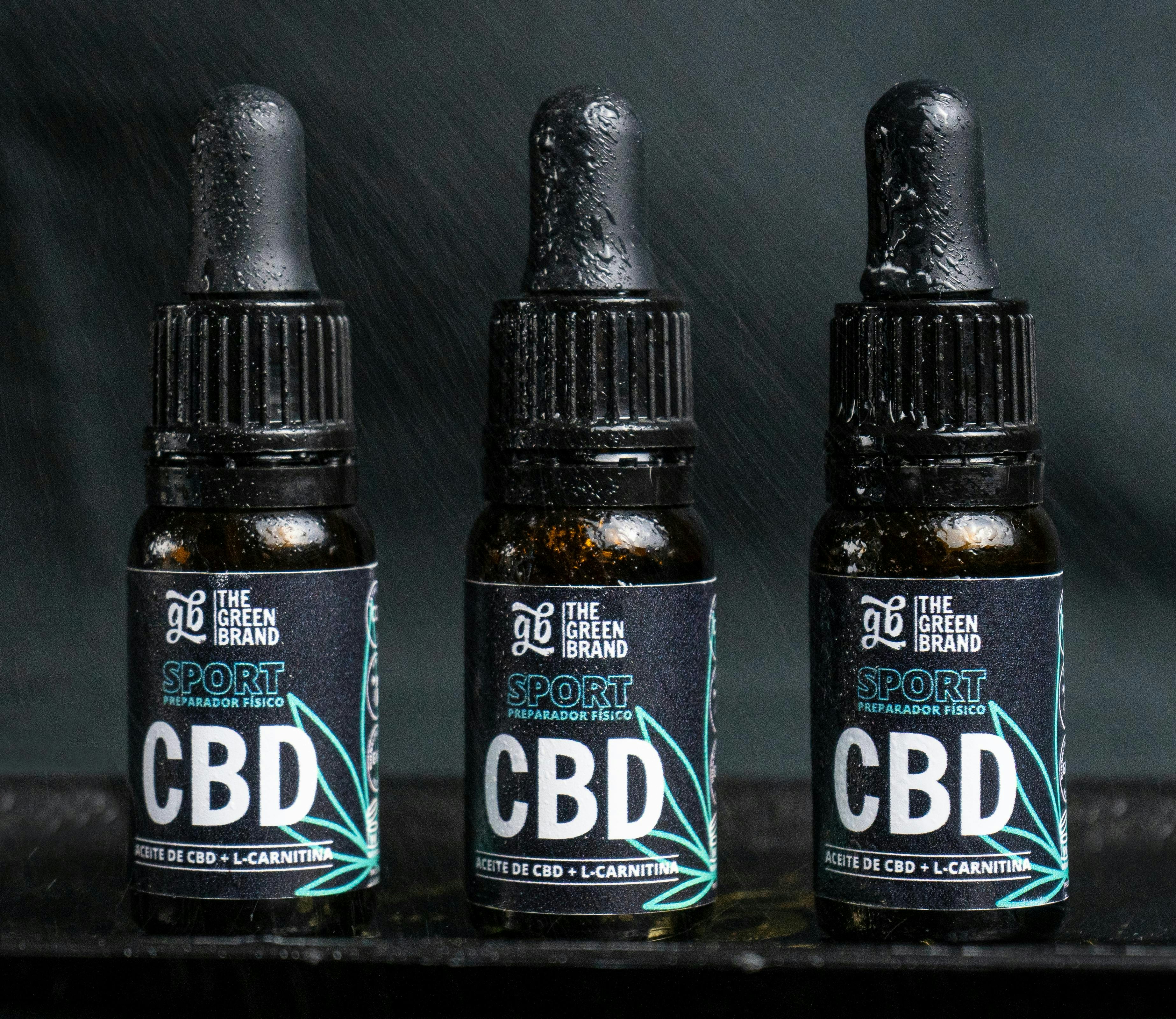 Three bottles of cbd sitting next to each other