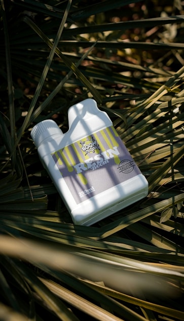 A bottle of lotion sitting on top of a palm tree