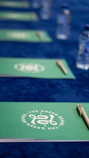 A close up of a table with pens and water bottles