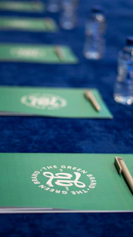 A close up of a table with pens and water bottles