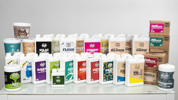 A white table topped with lots of bottles of liquid