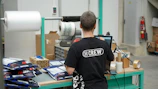 A man standing in front of a machine in a factory
