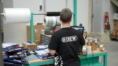 A man standing in front of a machine in a factory