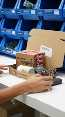 A woman is typing on a laptop at a desk
