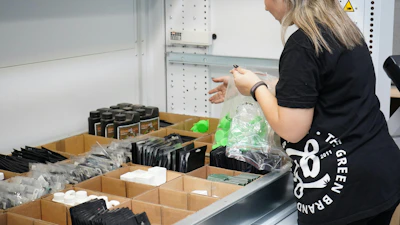 A woman standing in front of a metal sink