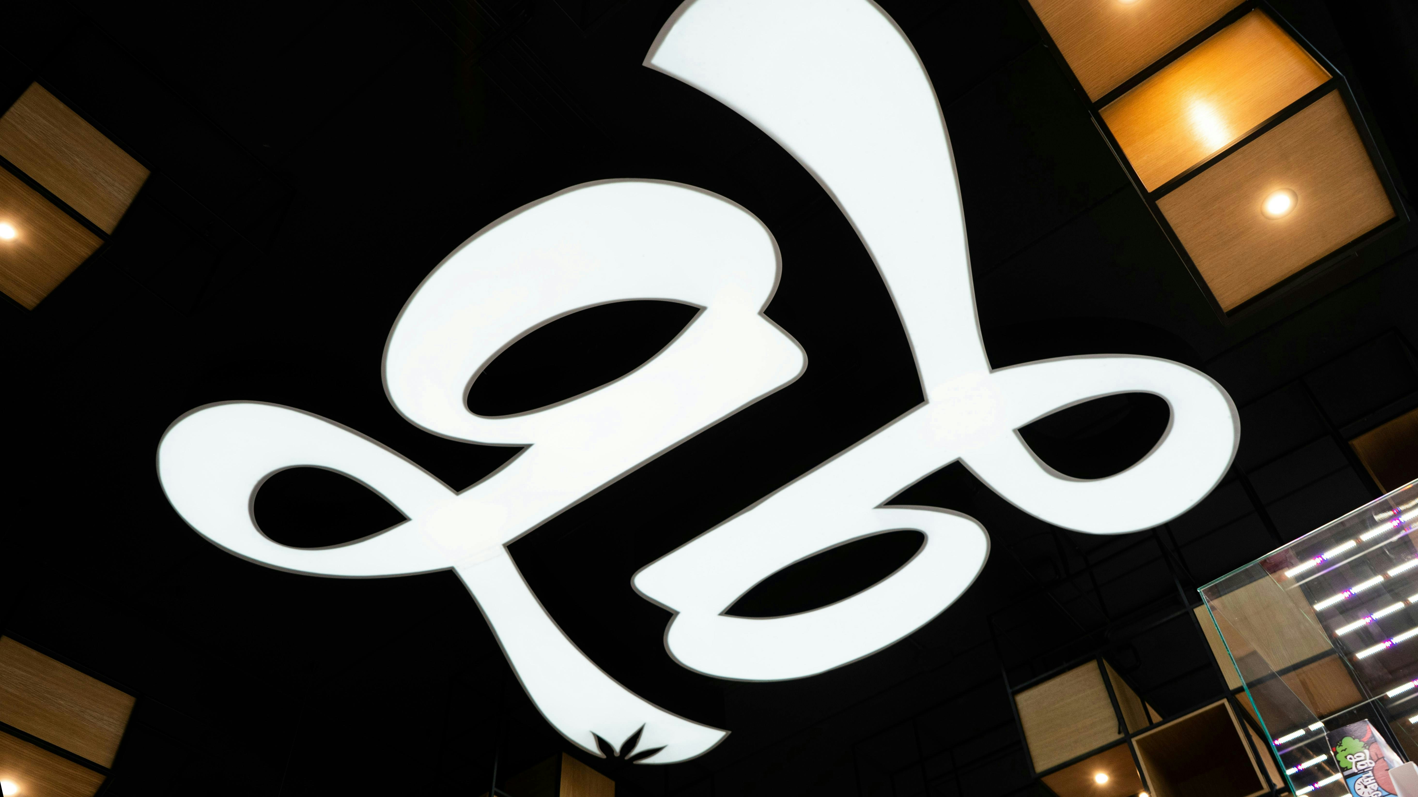 A large white sign hanging from the side of a building