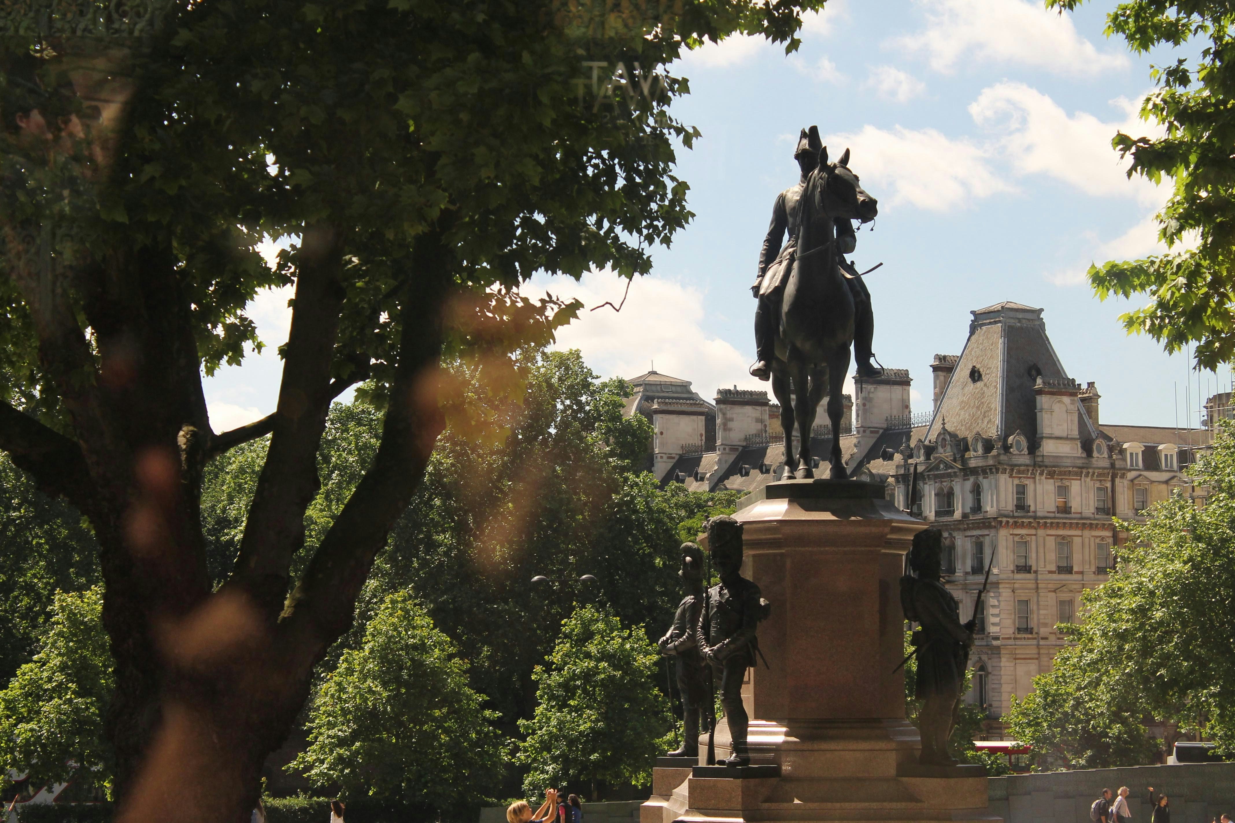 A statue of a man on a horse in a park