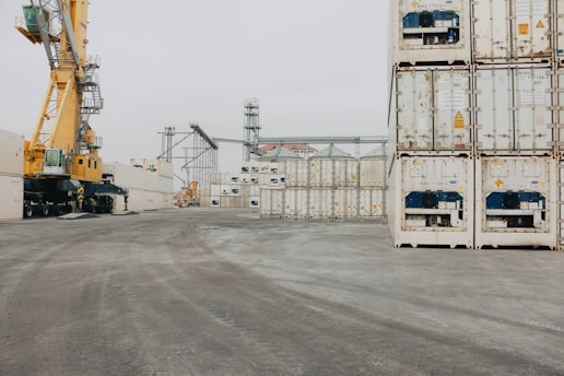 A large crane is next to a large container