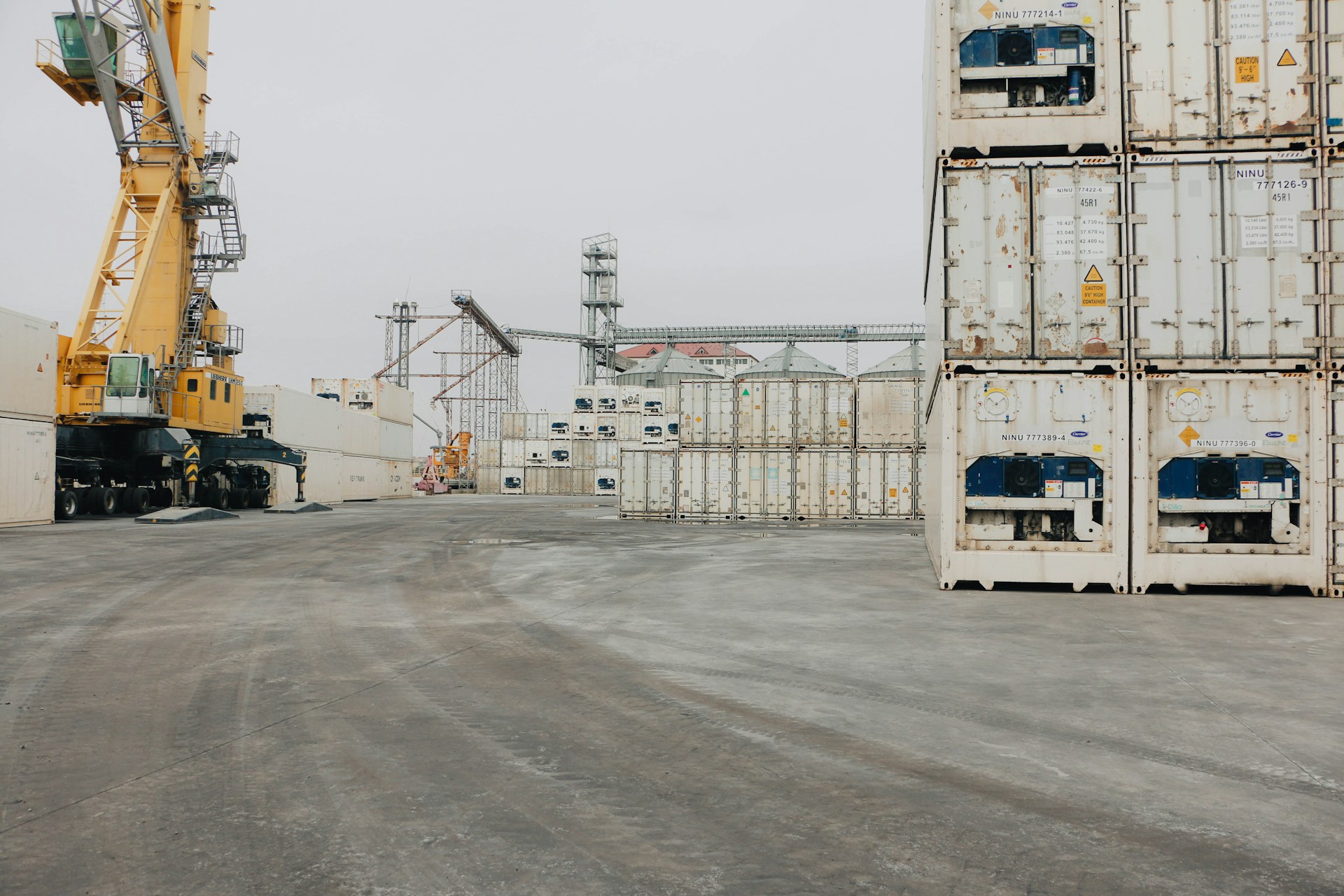 A large crane is next to a large container