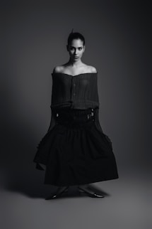 A black and white photo of a woman in a dress