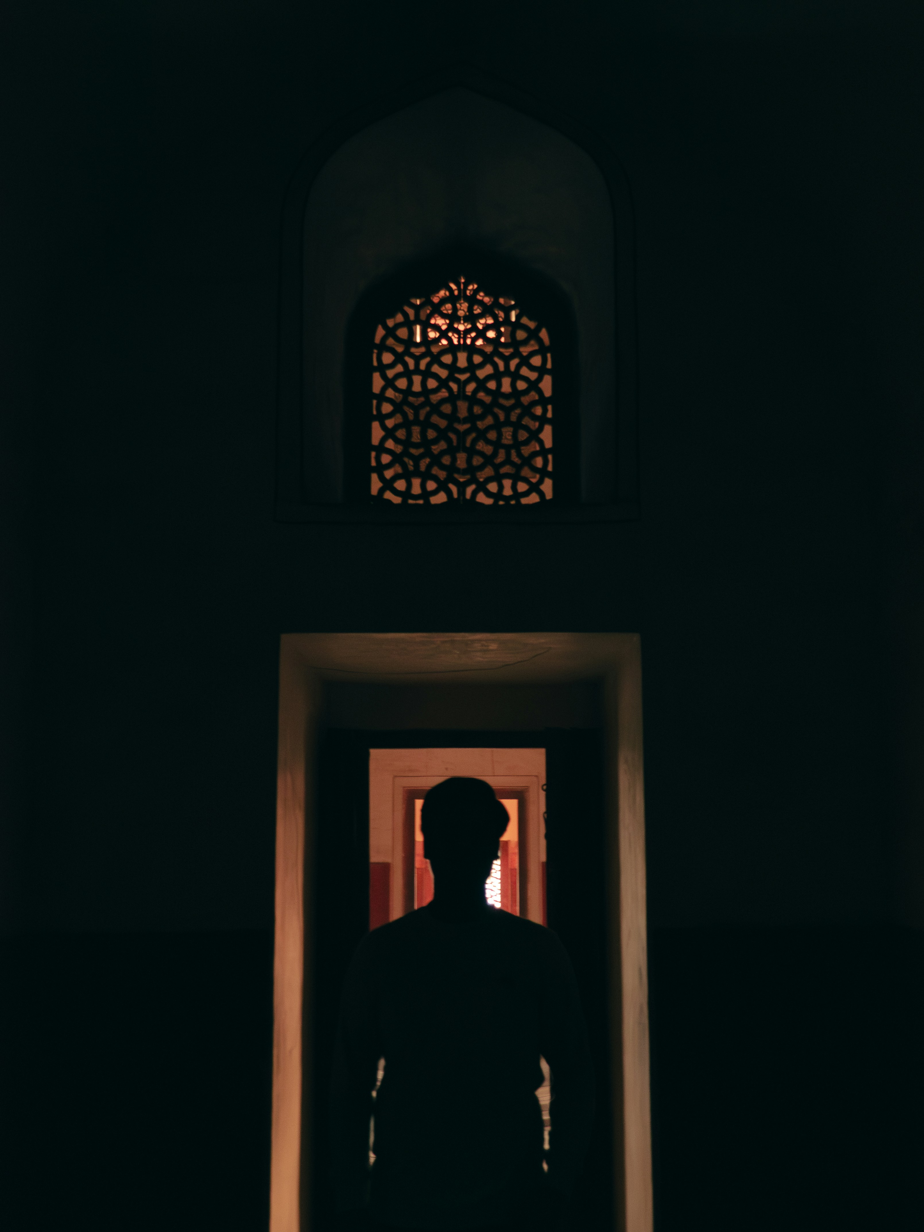A man standing in a doorway at night
