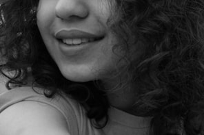 A black and white photo of a woman with curly hair