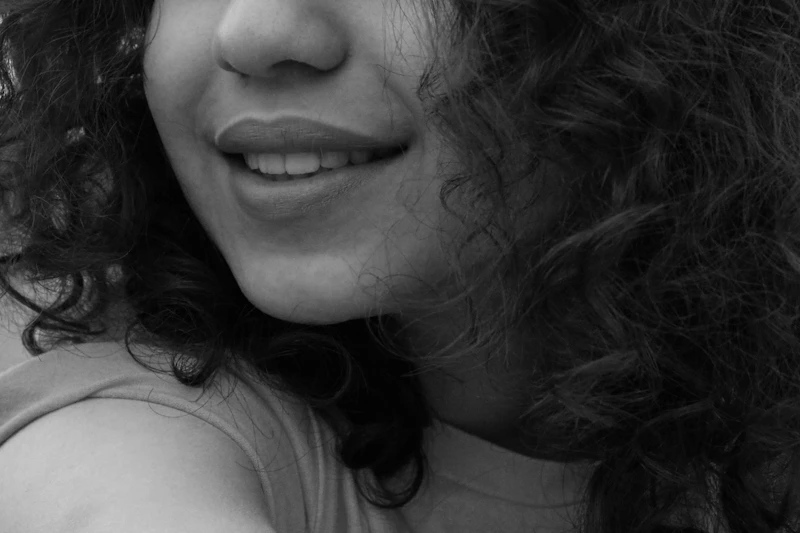 black and white portrait of a curly-haired woman
