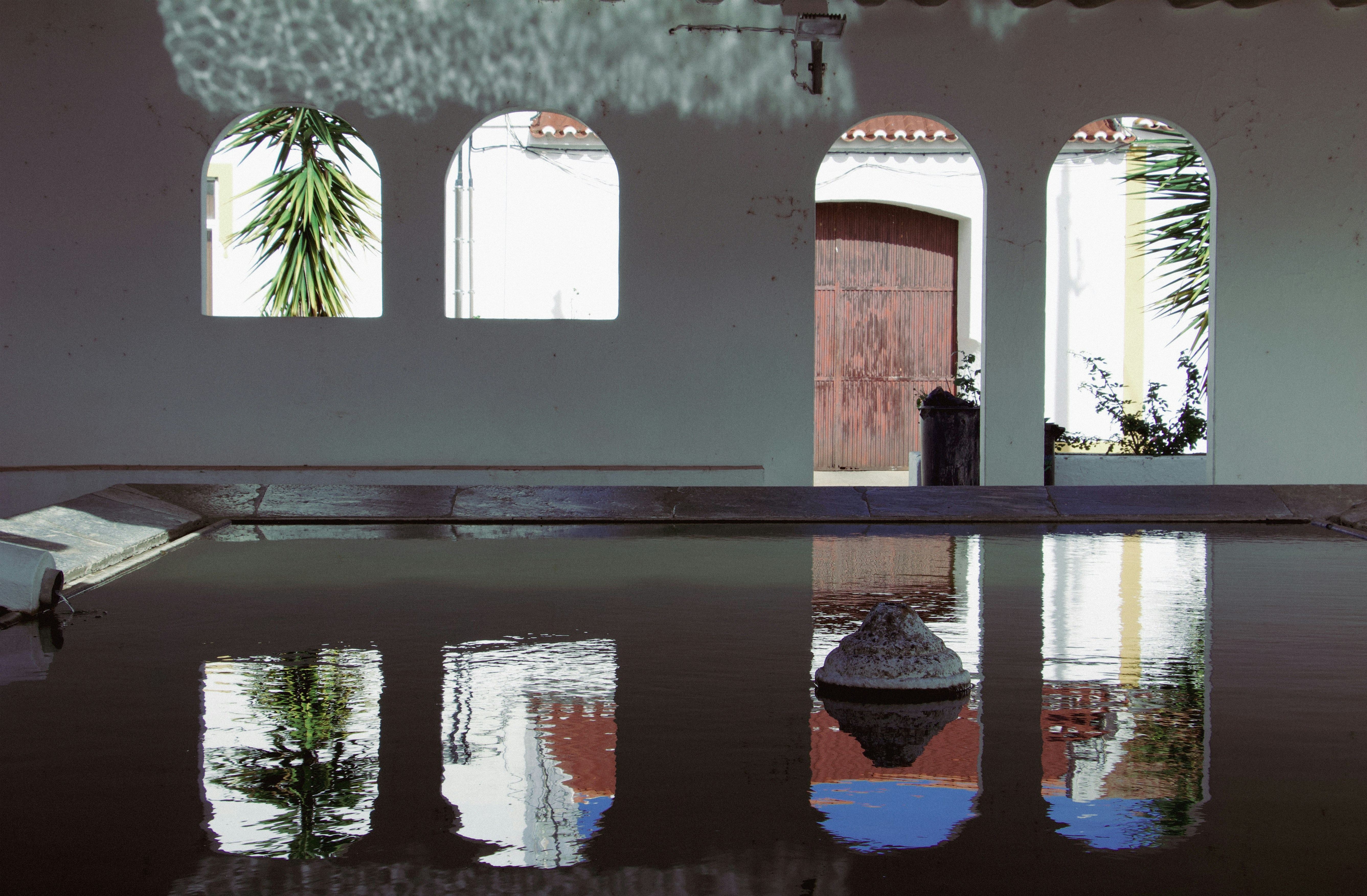 A large room with a pool and several windows