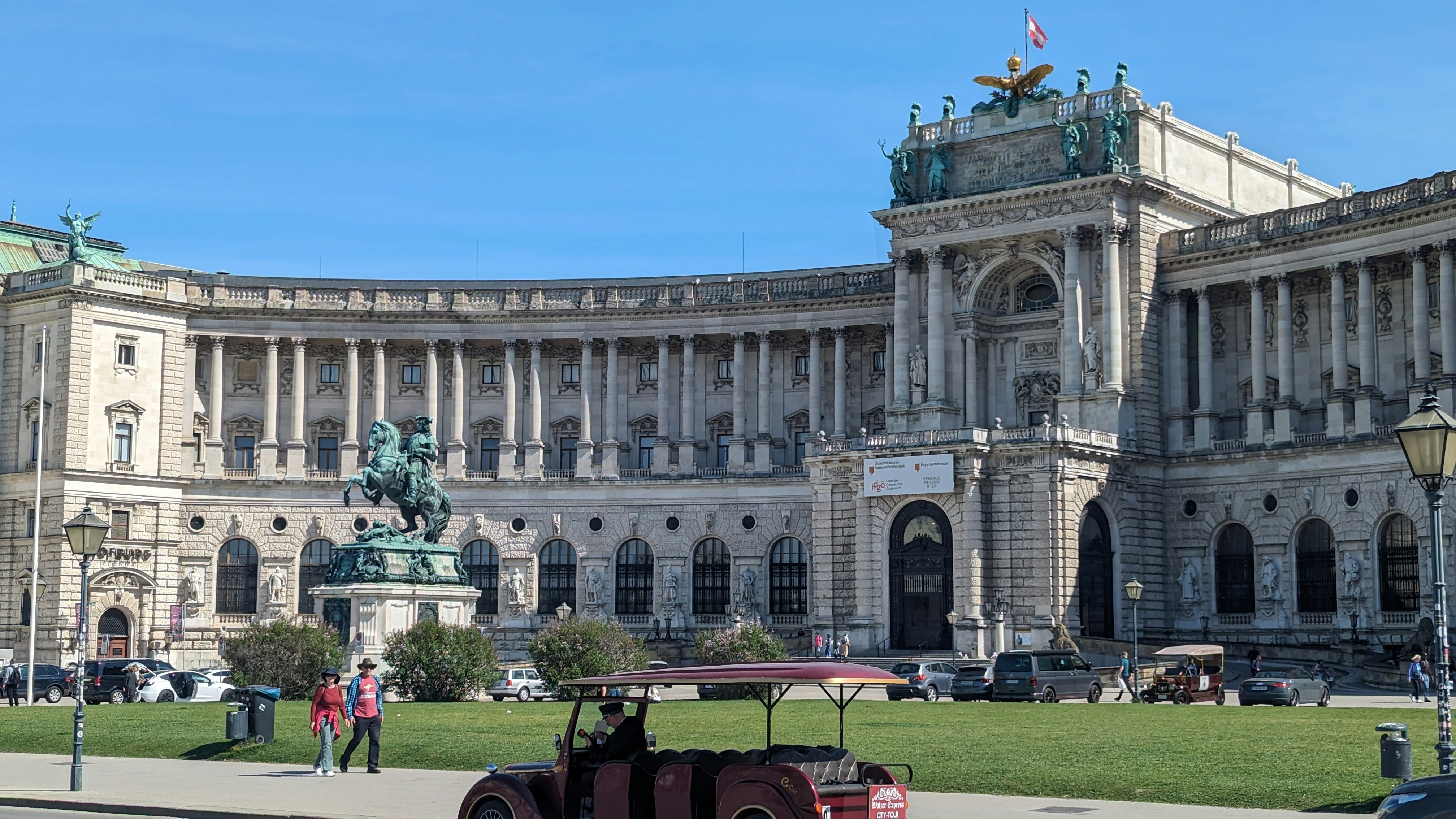 A car parked in front of a large building