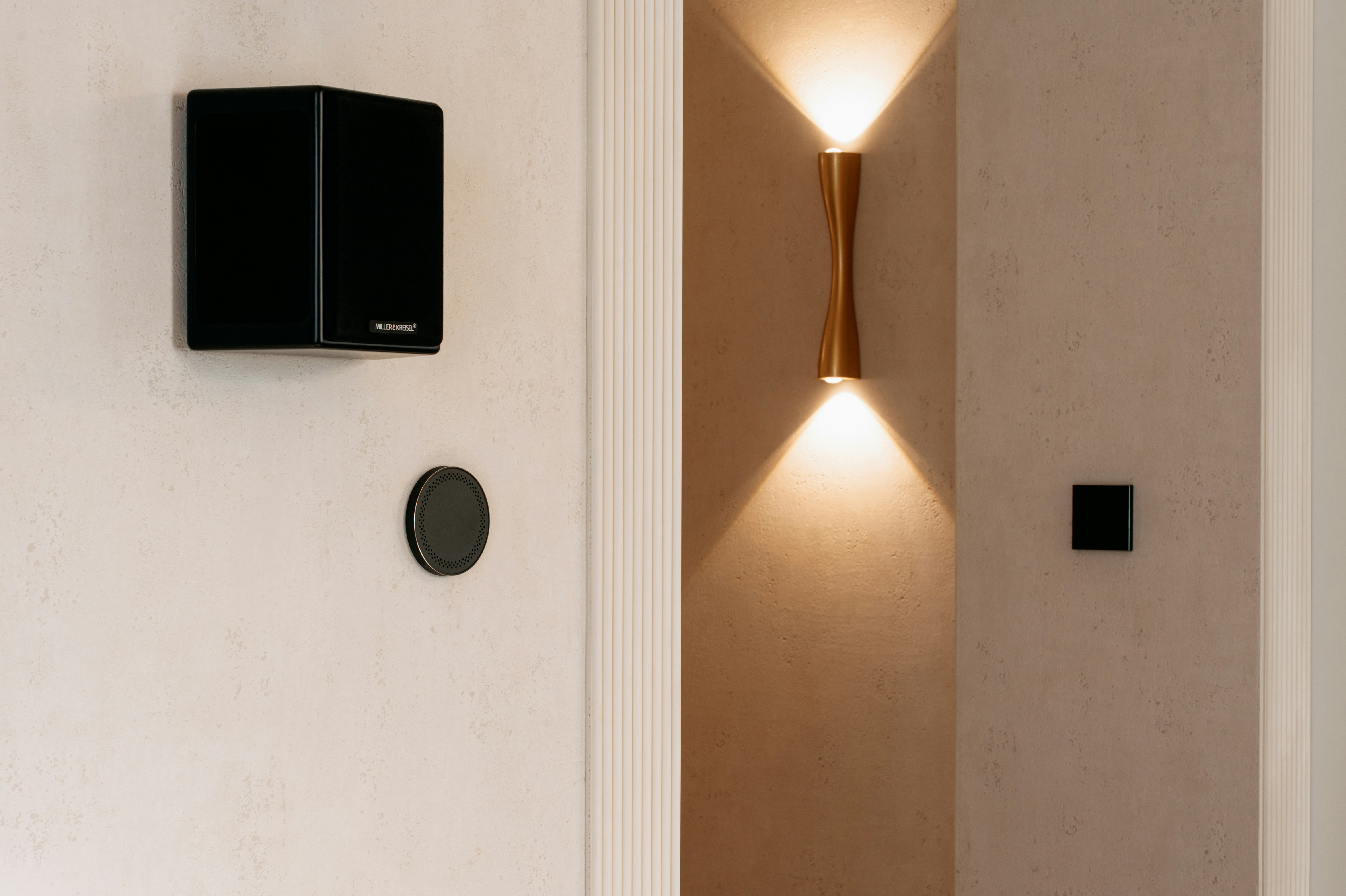 A wall mounted light next to a white door