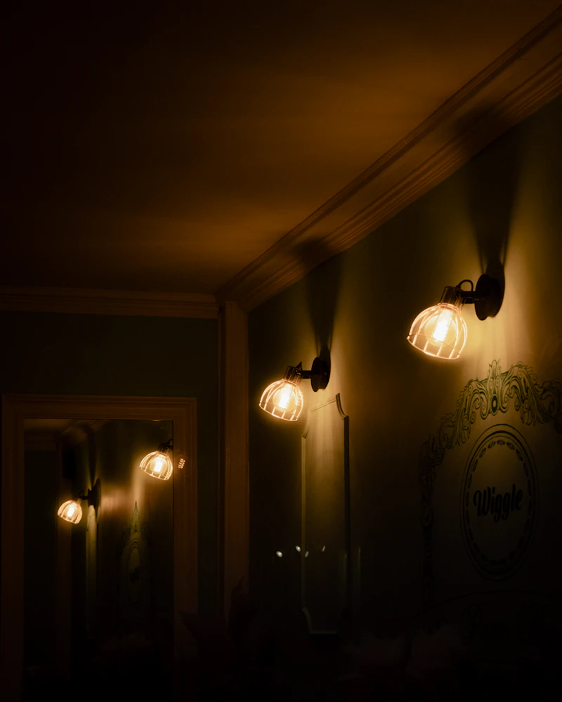 Dimly lit private dining room with three wall sconces
