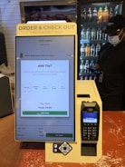 A checkout counter with a cell phone on it