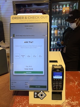 A checkout counter with a cell phone on it