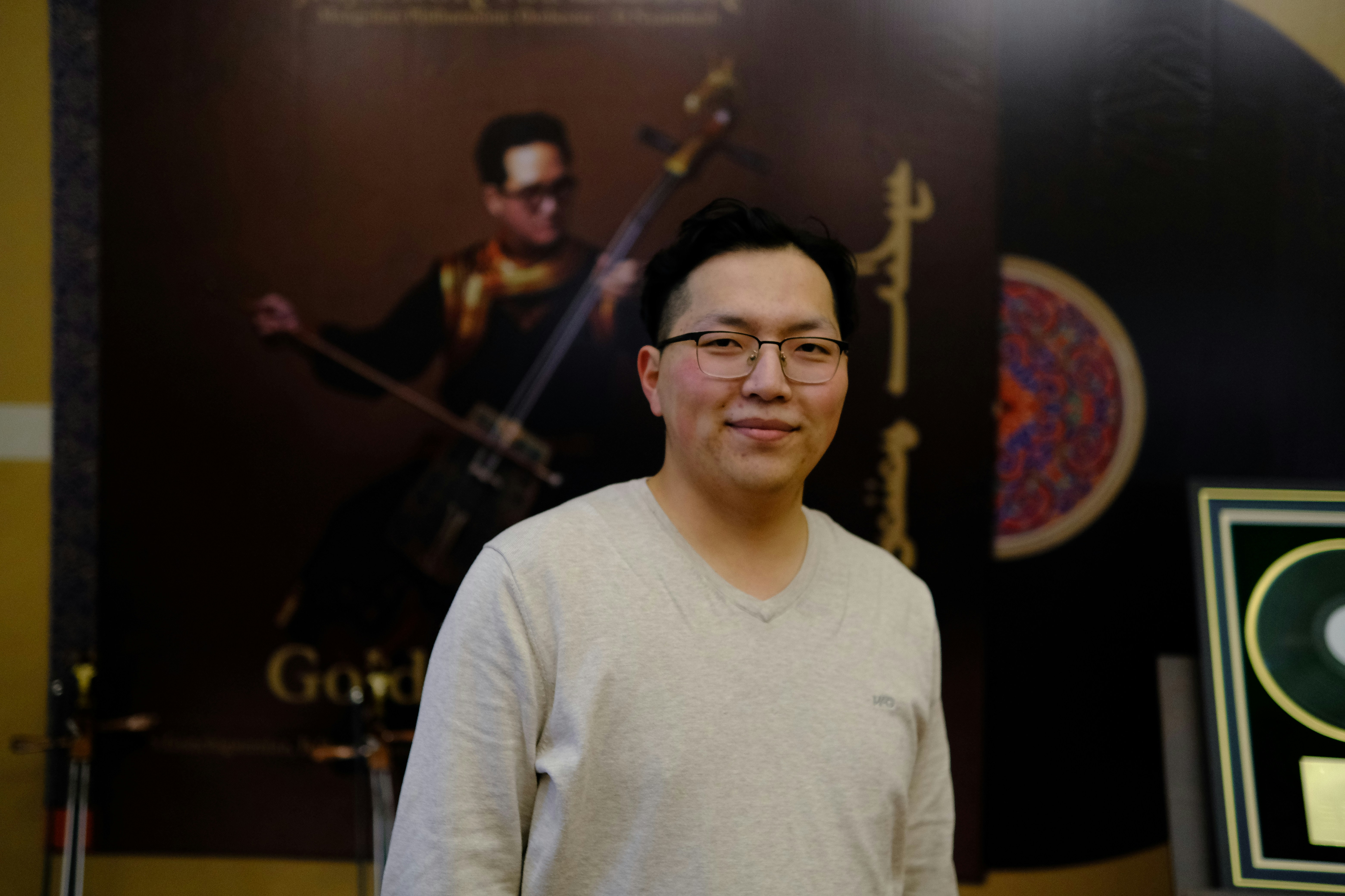 A man standing in front of a poster